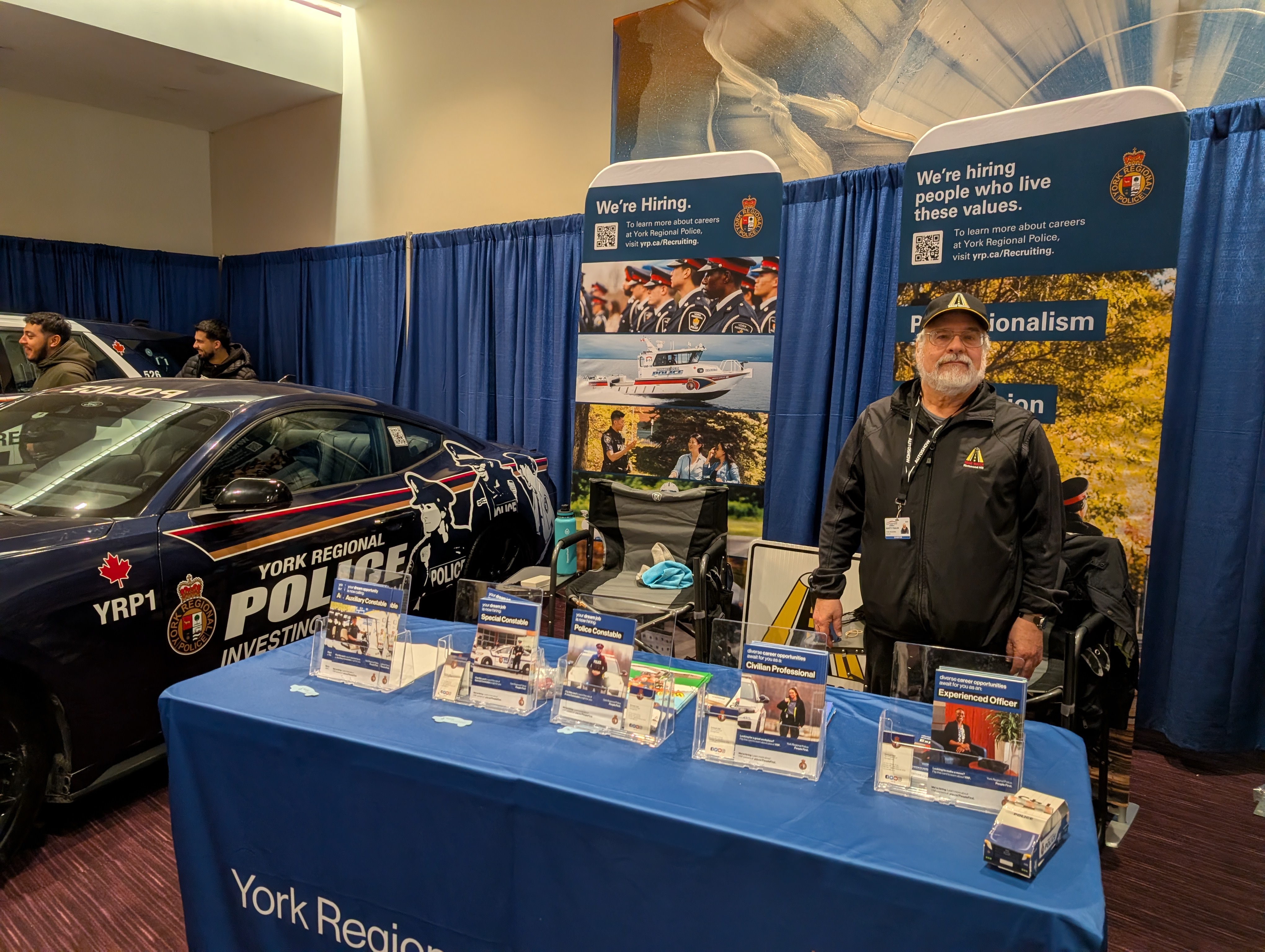 Marty Paulin standing at the YRP Road Watch booth at the Canadian Auto Show