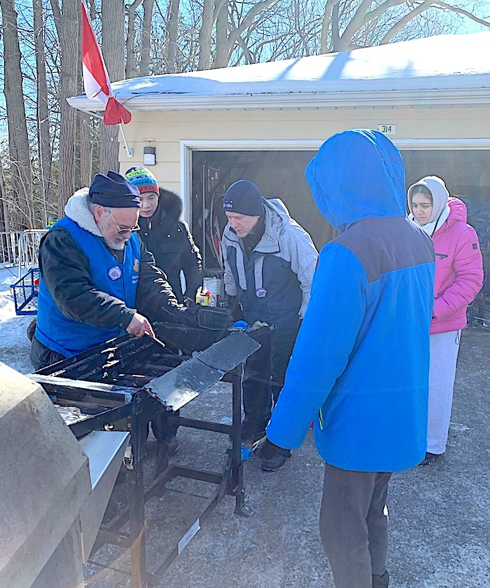 Marty Paulin cooking food at the Richmond Hill Winter Carnival